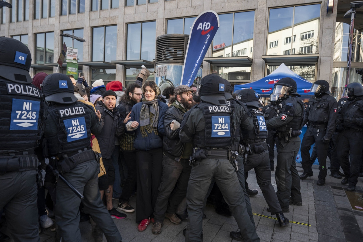 Die Polizei muss einen Wahlkampfstand der AfD schützen.