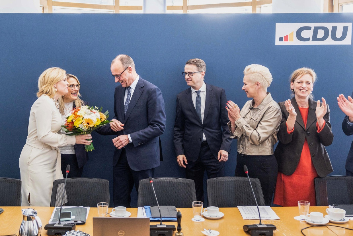 Julia Klöckner überreicht Friedrich Merz am Tag nach der Bundestagswahl einen Blumenstrauß; mit auf dem Bild zu sehen sind Christina Stumpp, Carsten Linnemann, Silvia Breher und Karin Prien.