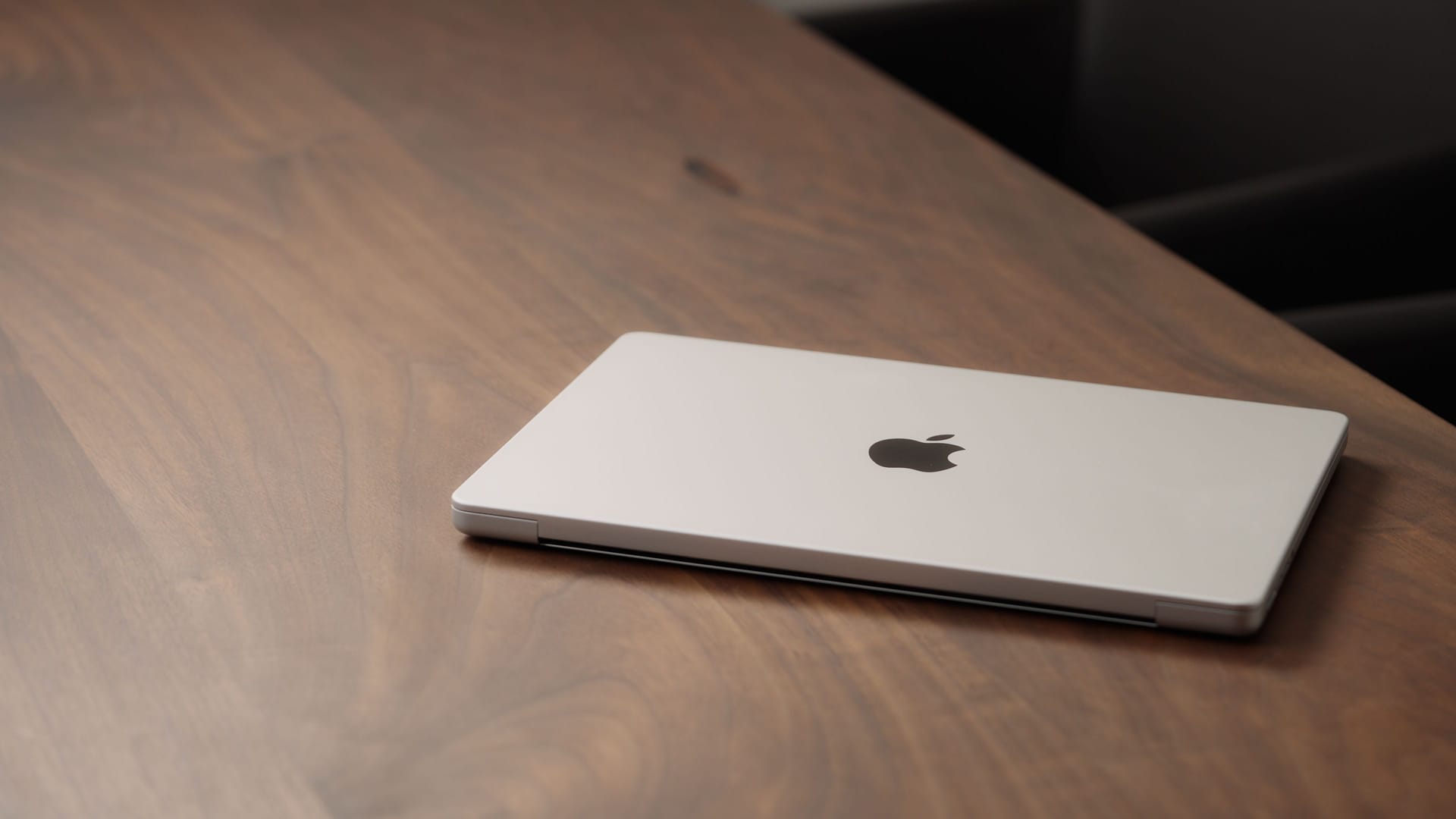 Saint-Petersburg, Russia - Circa December, 2022: CLoseup of the Macbook on walnut wood table with Saint-Petersburg, Russia - Circa December, 2022: CLoseup of the Macbook on walnut wood table with