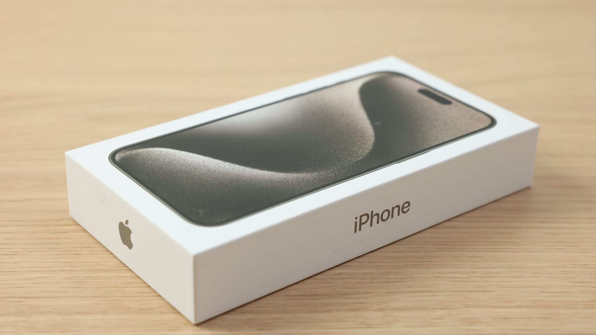 Leiden, Netherlands - October 6, 2023: Box with iPhone 15 Pro Max on wooden table Leiden, Netherlands - October 6, 2023: Box with iPhone 15 Pro Max on wooden table