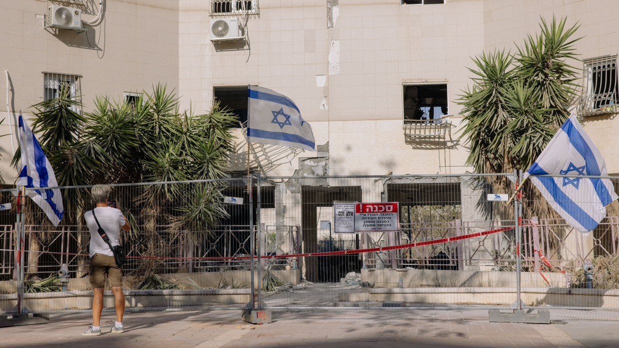 Ein Passant fotografiert ein zerstörtes Haus in einem Wohngebiet in Beerscheva in Israel, das am 24. Juni von einer iranischen Rakete getroffen wurde.