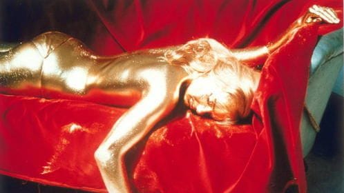 Eine Frau liegt auf dem Sofa. Sie ist vollständig mit Gold überzogen. Es handelt sich um eine Szene aus dem Film "James Bond 007 Goldfinger". Eine Frau liegt auf dem Sofa. Sie ist vollständig mit Gold überzogen. Es handelt sich um eine Szene aus dem Film "James Bond 007 Goldfinger".