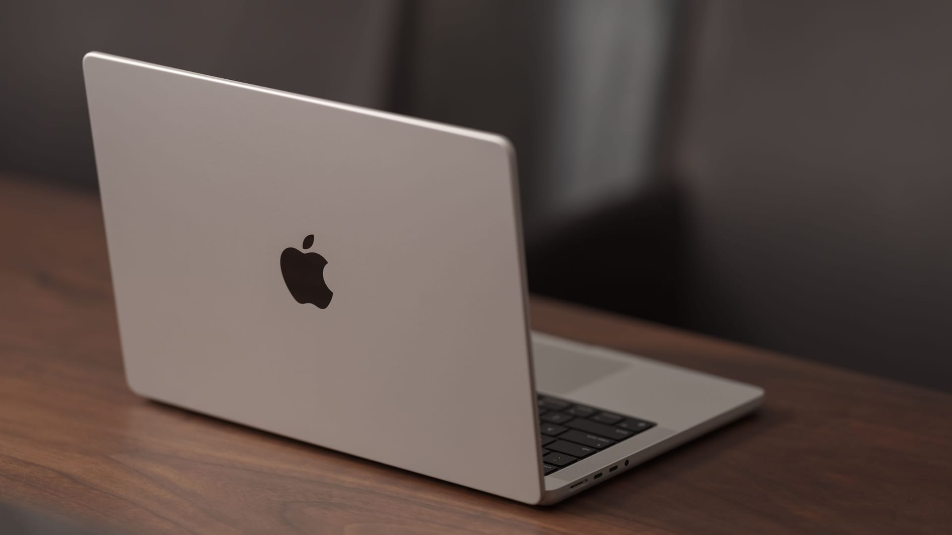 Saint-Petersburg, Russia - Circa December, 2022: open apple macbook pro 14 inch on walnut table Saint-Petersburg, Russia - Circa December, 2022: open apple macbook pro 14 inch on walnut table