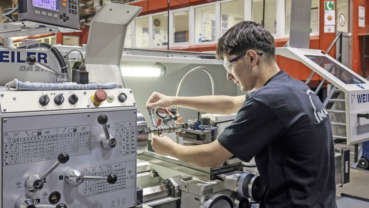 Handfest: Ein Auszubildender arbeitet an einer Werkzeugmaschine
