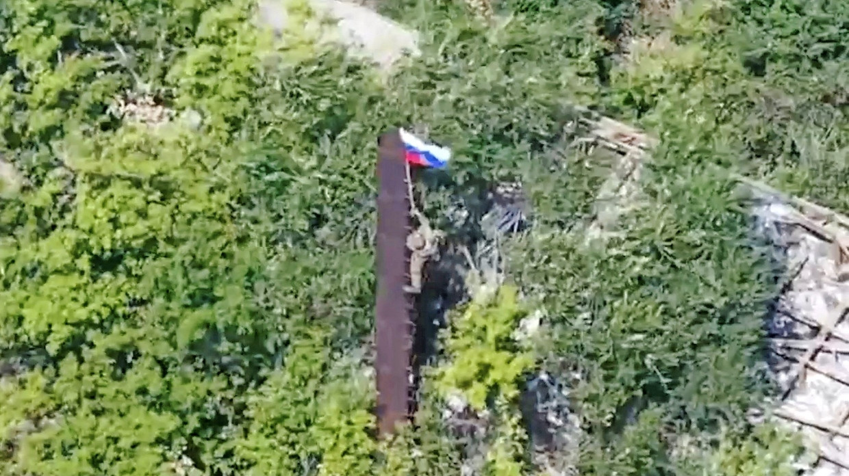 Ein russisches Propagandabild: Ein Soldat hisst in Yablunivka im Oblast Donezk die russische Flagge.